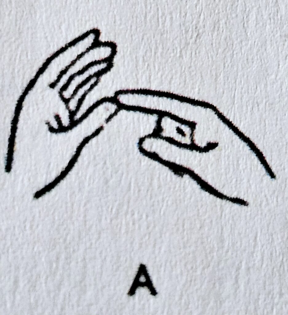 The letter A sign in Makaton
