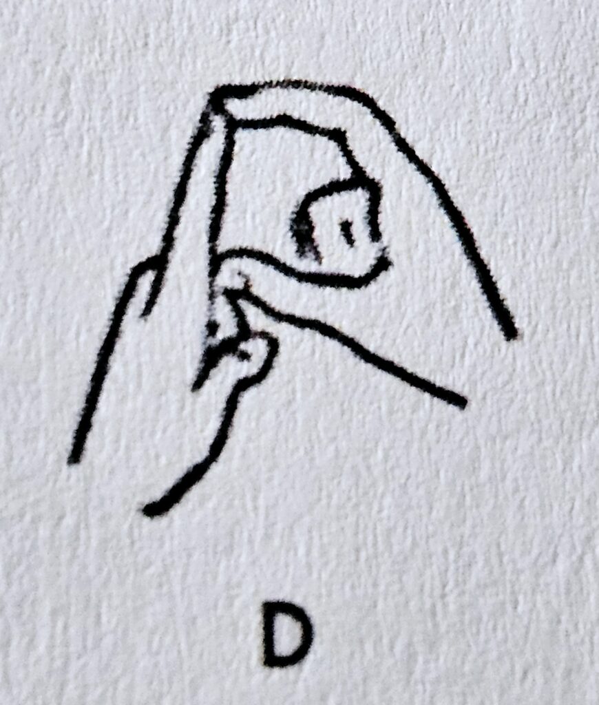 The letter D in Makaton